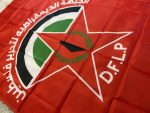 Discover the DFLP Flag, a high-quality reproduction representing the Democratic Front for the Liberation of Palestine. Measuring 90 cm in length and 150 cm in height, this flag is meticulously crafted from durable polyester, ensuring vibrant colors and long-lasting use. The design features a striking red background with the DFLP emblem prominently displayed, making it a perfect addition for collectors, reenactors, archivists, and historians. This versatile flag is ideal for historical reenactments, educational displays, and archival purposes. It comes with reinforced edges and two metal grommets for easy hanging on flagpoles, walls, or within display cases. Honor the legacy of the Democratic Front for the Liberation of Palestine by adding this emblematic piece to your collection today.