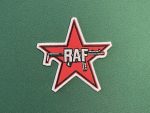 Embrace a piece of revolutionary history with the Red Army Faction (RAF) Star Patch. This 4-inch tall patch prominently features a red star with the letters “RAF” overlaying a stylized machine gun, representing the infamous left-wing militant group from Germany. The RAF, also known as the Baader-Meinhof Group, was active from the 1970s to the 1990s, known for its radical stance and numerous high-profile actions against capitalist and imperialist targets . Backing Options: • Velcro Backing: Ideal for easy attachment and removal. • Iron-On Backing: Perfect for a secure, permanent application. • No Backing: Suitable for those who prefer to sew the patch onto their gear. Perfect for collectors, reenactors, archivists, and history enthusiasts, this patch serves as a bold statement piece and a reminder of the turbulent era of political activism in Europe. Add this unique and historically significant patch to your collection today!