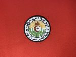 This patch features the emblem of the National Liberation Front (FLN) of Algeria, with intricate Arabic text, a flame, star, crescent, and a sunburst design. Measuring 3.5 inches in diameter, this patch is available with Velcro backing, iron-on backing, or no backing for sewing, making it a versatile addition to any collection. Ideal for collectors, reenactors, and historians.