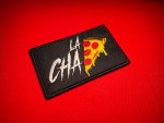 Black embroidered Chapiza patch associated with the Chapitos faction, featuring “La CHA” lettering and a dripping pepperoni pizza slice design on a red fabric background.