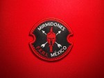 Embroidered Mirmidones F.E.R.I. patch from the Mexican National Guard, featuring a Spartan helmet with crossed weapons and circular red-and-black design.