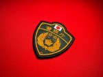 Embroidered green and gold Japanese National Police Agency (警察庁) shield patch featuring the Hinomaru flag at top and the traditional Japanese police crest surrounded by a laurel wreath.
