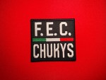Black rectangular F.E.C. CHUKYS patch replica with white lettering and a horizontal green, white, and red center stripe, associated with Los Chukys and the Cártel del Noreste in northeastern Mexico.