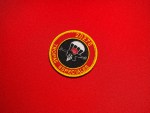 Cuban Tropas Especiales Unit 20270 patch with parachute, clenched fist holding rifle, and red black design