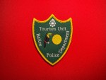 Belize Police Department Tourism Unit patch with toucan and sun on green shield, yellow border, embroidered police insignia 3.8x3 inches