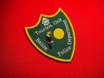 Belize Police Department Tourism Unit patch with toucan and sun on green shield, yellow border, embroidered police insignia 3.8x3 inches