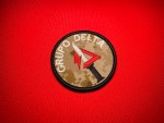 CJNG Grupo Delta 3-inch round embroidered patch with desert MARPAT-style camouflage background, white lettering, and central red delta emblem over a silver knife with black handle.