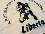 Corsican Ribellu nationalist flag featuring a black rebel figure, “A Populu Fattu Bisogna A Marchja” slogan, “Liberta” text, white field, and left-side pole sleeve.