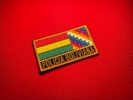 Policía Boliviana embroidered patch featuring the Bolivia tricolor flag, Wiphala emblem, gold border, and yellow police lettering on a black panel.