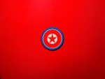North Korean Ministry of Social Security embroidered DPRK roundel shoulder patch with red star, white center, red field and blue border on a red background.