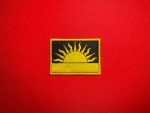 Biafran Rising Sun embroidered reproduction patch featuring a yellow rising sun on a black field with yellow border.