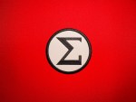 -inch reproduction AIB Sigma uniform insignia featuring a black Sigma emblem on a white circular field with a black embroidered border.