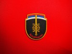 Front view of Serbian Škorpioni Scorpions sword insignia patch with Serbian flag colors, gold sword, ocila firesteels, and red Cyrillic lettering.