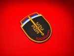 Serbian Škorpioni Scorpions sword patch with Serbian tricolor, gold sword, firesteels, and Cyrillic unit name on black shield.