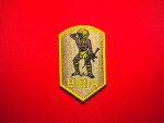 El Salvador BIRIA Atlacatl reproduction patch featuring a feathered warrior holding an M16 rifle, tan background, yellow border, and BIRIA lettering.